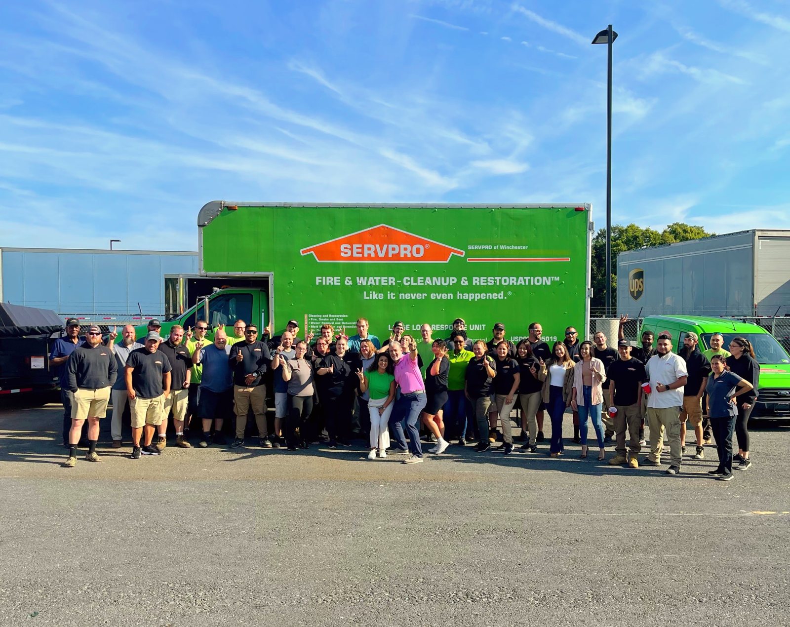 Jennifer with the SERVPRO Team Warnecki crew in front of a company truck